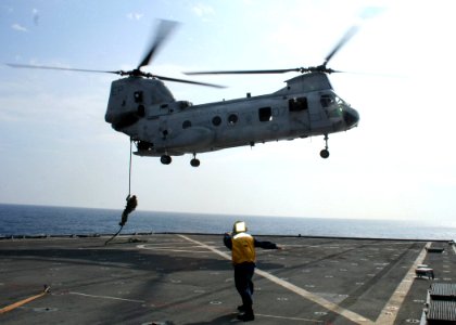 US Navy 070221-N-6710M-004 Members from the 31st Marine Expeditionary Unit fast rope from a hovering CH-46 helicopter in preparations for a profile exercise with members from USS Tortruga (LSD 46) Visit, Board, Search and Seiz photo