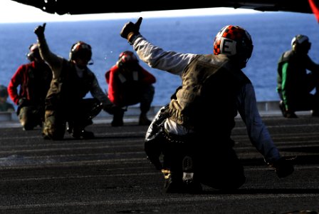 US Navy 070216-N-3729H-046 Final checkers give the okay for an F-A-18C Hornet from the Death Rattlers of Marine Fighter Attack Squadron Three Two Three (VMFA-323) to launch off the flight deck