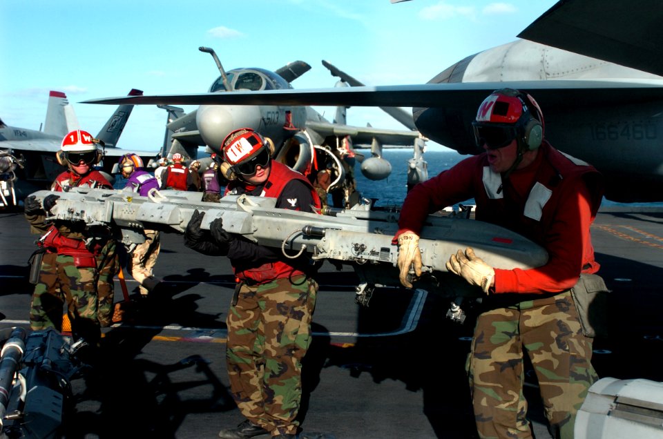 US Navy 070301-N-4420S-205 Three Sailors assigned to the Black Aces of Strike Fighter Squadron (VFA) 41, arm a missile and bomb rack to an F-A-18E Super Hornet aboard nuclear-powered aircraft carrier USS Nimitz (CVN 68)