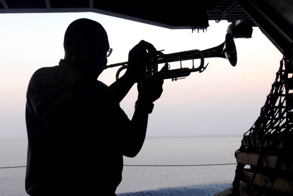 US Navy 070218-N-2659P-015 Ship's Serviceman 3rd Class Marcus Williams plays the trumpet in the hangar bay during a ceremony to celebrate African American Heritage month aboard the Nimitz-class aircraft carrier USS John C. Sten