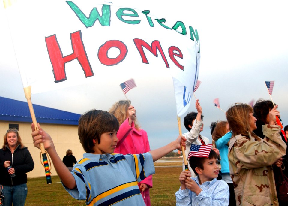 US Navy 070222-N-3285B-009 A young boy holds a sign welcoming home his dad, a Sailor attached to Carrier Strike Group Six who spent a year assigned to the staff of Combined Joint Task Force-Horn of Africa (CJTF-HOA) in Djibouti