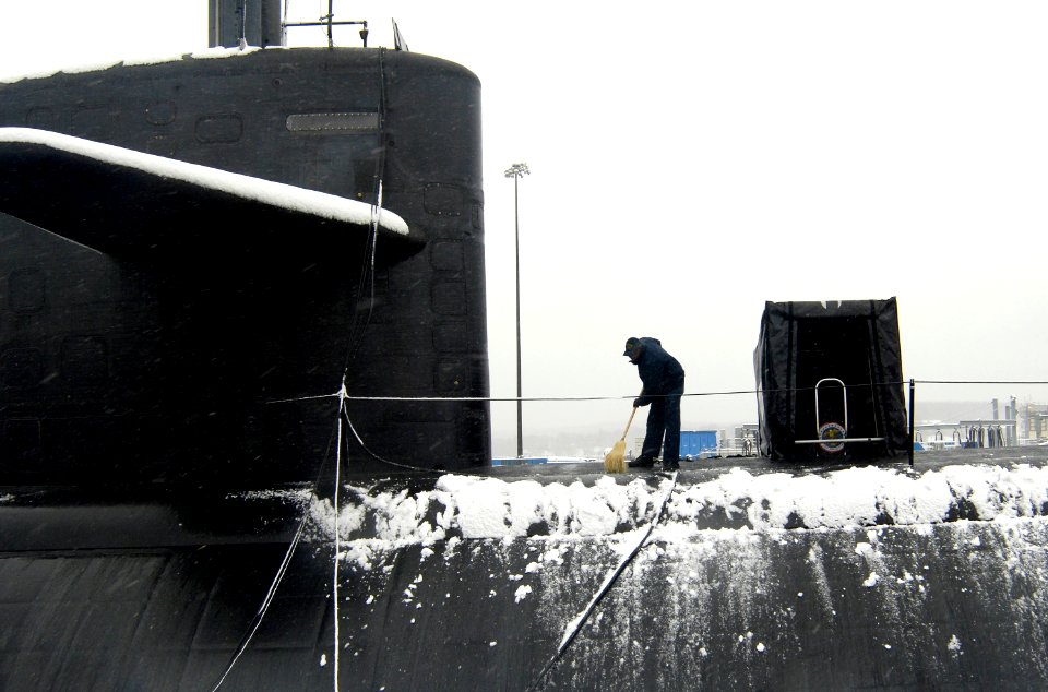 US Navy 070226-N-8467N-001 Machinist's Mate 2nd Class Alvin Anyiah removes snow from fast attack submarine USS Philadelphia (SSN 690) at Submarine Base New London