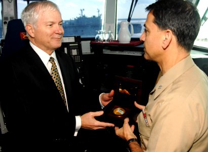 US Navy 070222-N-8923M-073 Secretary of Defense (SECDEF), the Honorable Dr. Robert M. Gates, presents his ceremonial coin to Commanding Officer Capt. Herman Shelanski on the bridge aboard USS Harry S. Truman (CVN 75)