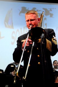 US Navy 070218-N-7656R-001 Chief Musician Robert Watson, Navy Band Northwest operations chief, plays his trombone in a solo portion of a song at a jazz concert photo
