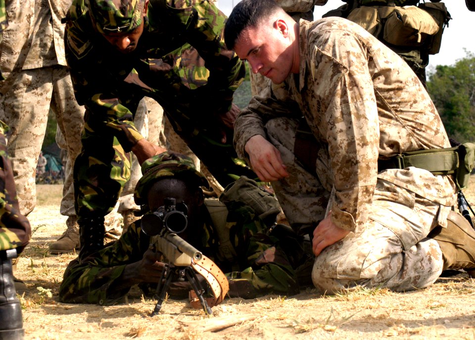 US Navy 070304-N-8154G-076 Cpl. Jon Edell, assigned to Battalion Landing Team (BLT) 2-2 Fox Company, 26th Marine Expeditionary Unit (MEU), assists a member of the Kenyan army