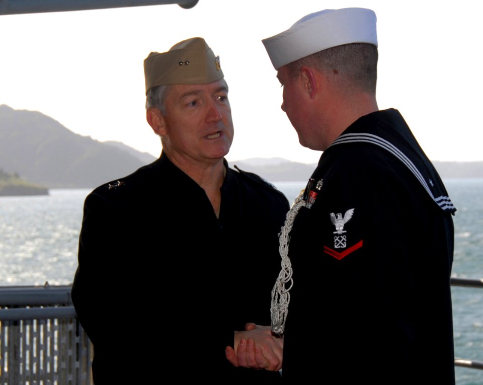 US Navy 070228-N-3659B-026 Rear Adm. James D. Kelly, Commander U.S. Naval Forces Japan, (CNFP) shakes hands with the boatswain's mate that piped him aboard USS Ronald Reagan (CVN 76)