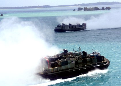 US Navy 070301-N-6710M-008 Two landing craft air cushions (LCAC) prepare to enter the well deck of dock landing ship USS Tortuga (LSD 46) after conducting LCAC maintenance turns near White Beach Naval Facility Okinawa, Japan