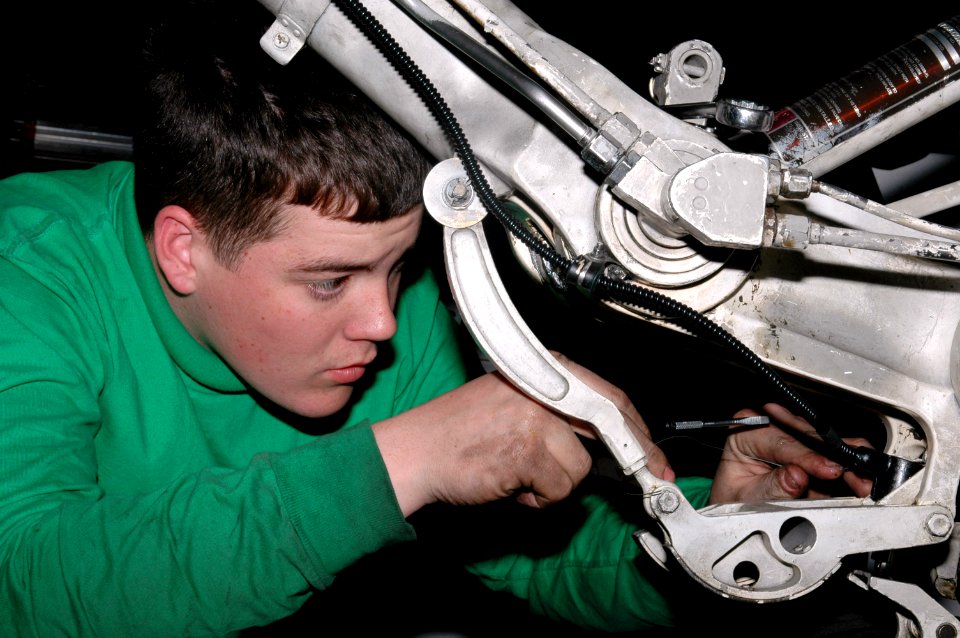 US Navy 070224-N-9760Z-027 Aviation Electrician's Mate Airman Brian Mollitor assigned to the Sunliners of Strike Fighter Squadron (VFA) 81 works on the wheel safety wiring of an F-A-18 Hornet aboard nuclear