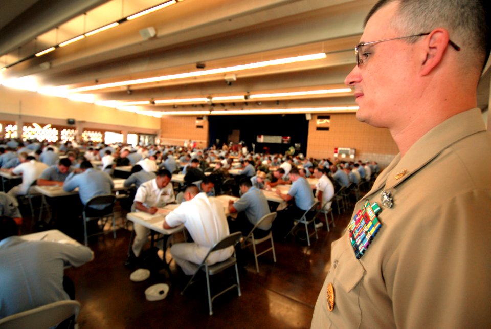 US Navy 070301-N-4965F-001 Chief Quartermaster Robert Collins, senior enlisted advisor and navigator assigned to High Speed Vessel Swift (HSV 2), monitors second class petty officers while proctoring the E-6 exam