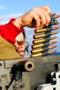US Navy 070225-N-6326B-031 Aviation Ordnanceman 3rd Class Shane Forsgren reloads a .50-caliber machine gun as part of a training exercise