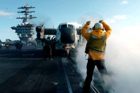 US Navy 070301-N-4420S-109 Aviation Boatswain's Mate (Handling) 3rd Class Baljeet Gill taxies an EA-6B Prowler assigned to the Black Ravens of Tactical Electronic Warfare Squadron (VAQ) 135 to the catapult aboard USS Nimi