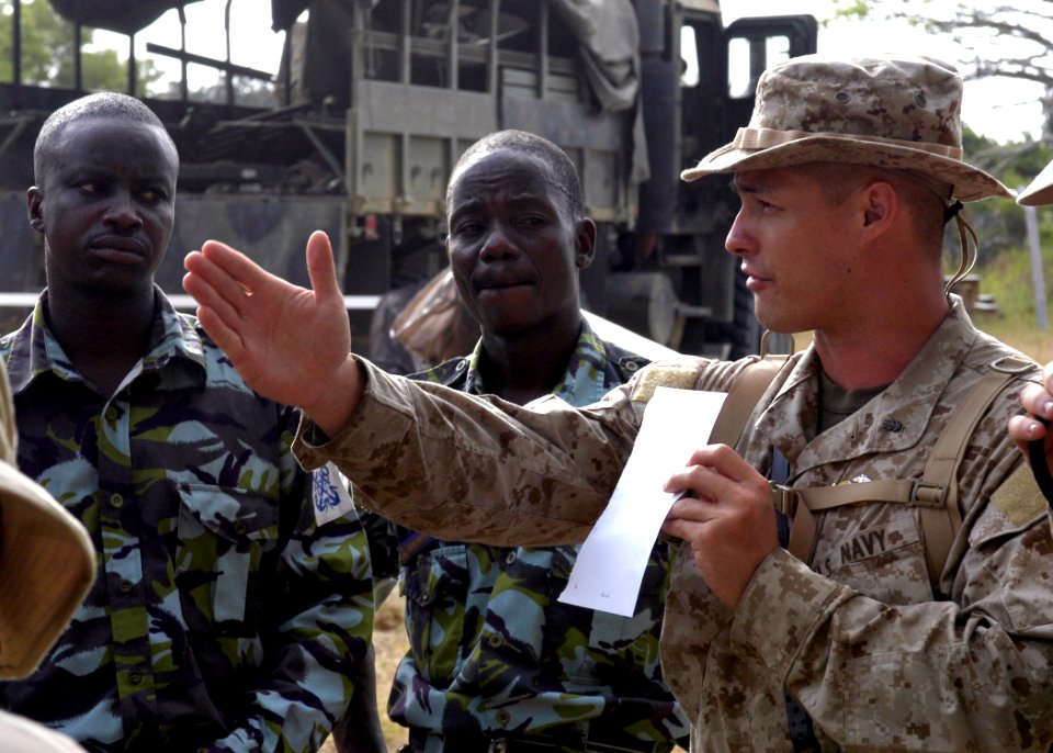 US Navy 070307-N-8154G-033 Lt. Kyle Kee, assigned to the 26th Marine Expeditionary Unit (MEU), explains the set up of the medical facilities and the order in which patients will be seen during the Medical Civil Assistance Proje