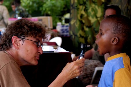 US Navy 070307-N-8154G-342 Lt. Cmdr. Patty Miller examines a patient during a Medical Civil Assistance Project (MEDCAP) at Barigoni School