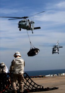 US Navy 070308-N-1328S-003 Marines assigned to combat cargo remove debris from the flight deck of amphibious assault ship USS Boxer (LHD 4) during a vertical replenishment with Military Sealift Command (MSC) fast combat support