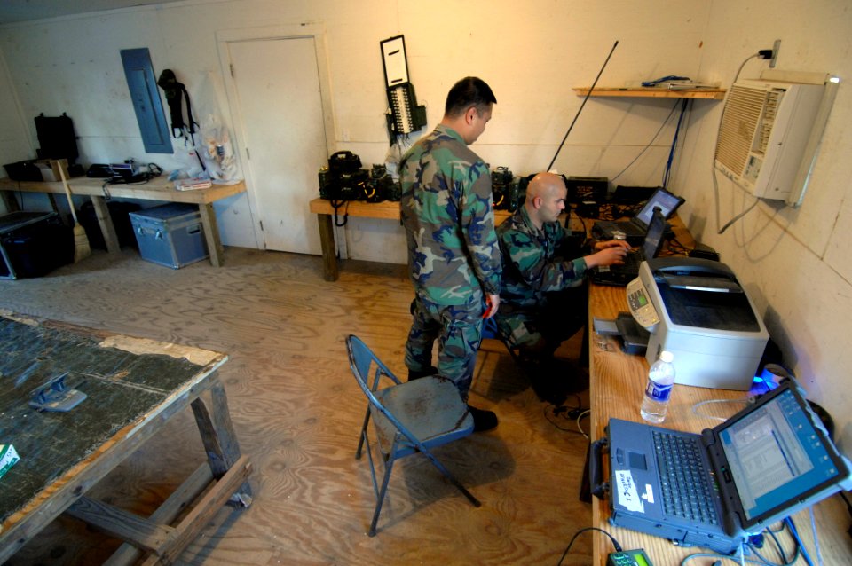US Navy 070226-N-2653P-006 Personnelman John Relojo and Construction Electrician 2nd Class Abel Arocha, assigned to Naval Mobile Construction Battalion (NMCB) 1, monitor intranet communications in the Regimental Operational and