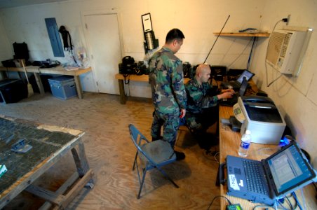 US Navy 070226-N-2653P-006 Personnelman John Relojo and Construction Electrician 2nd Class Abel Arocha, assigned to Naval Mobile Construction Battalion (NMCB) 1, monitor intranet communications in the Regimental Operational and