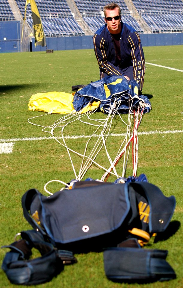 US Navy 070308-N-4163T-097 A member of the U.S. Navy Parachute Demonstration Team Leap Frogs repacks his parachute after landing into San Diego's Qualcomm Stadium during a training session