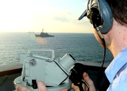 US Navy 070226-N-6710M-011 Quartermaster Seaman David B. Heismann takes bearings as dock landing ship USS Tortuga (LSD 46) passes through the busy waterways of Okinawa, Japan photo
