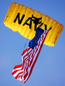 US Navy 070308-N-4163T-356 A member of the U.S. Navy Parachute Demonstration Team Leap Frogs descends into San Diego's Qualcomm Stadium with the American flag during a training session