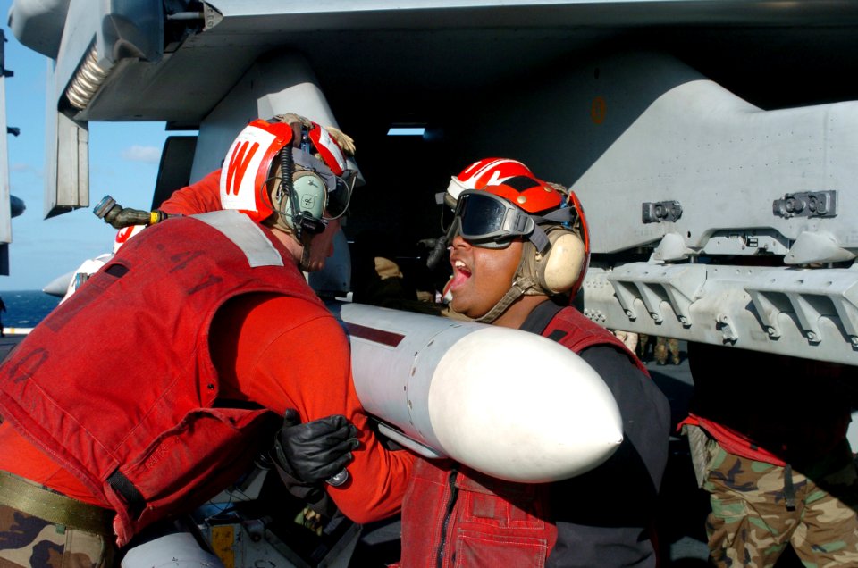 US Navy 070301-N-4420S-172 Sailors assigned to the Black Aces of Strike Fighter Squadron (VFA) 41, lift a missile on the flight deck aboard the nuclear-powered aircraft carrier USS Nimitz (CVN 68)