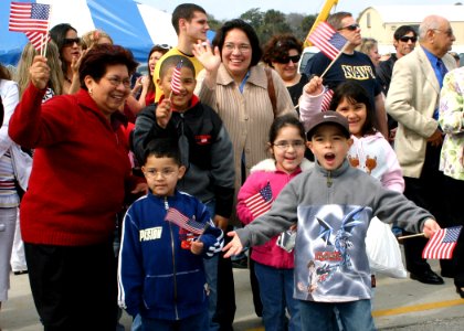 US Navy 070309-N-8544C-038 Family members of Electrician's Mate 2nd Class Juan Moreno await his arrival aboard guided missile frigate USS Taylor (FFG 50), as she pulls into homeport after a successful deployment