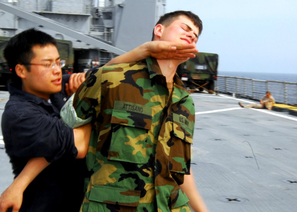 US Navy 070311-N-4124C-023 Engineman Fireman Apprentice Jimmy S. Seechang practices a restraining maneuver on Seaman Apprentice Lawrence L. Attisano as part of a Visit, Board, Search and Seizure (VBSS) dry-fire training day abo