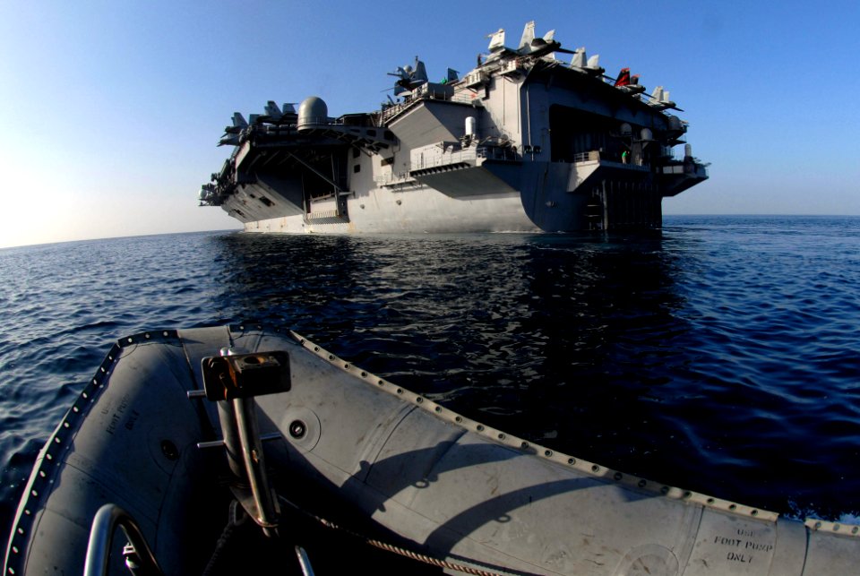 US Navy 070306-N-0684R-077 Boatswain's mates assigned to deck department steer a rigid hull inflatable boat (RHIB) toward the back end of Nimitz-class aircraft carrier USS John C. Stennis (CVN 74)