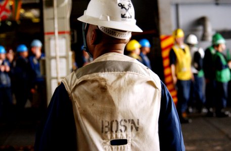 US Navy 070302-N-4009P-397 Chief Warrant Officer Rich Williams from Fort Lauderdale, Fla., oversees operations in hangar bay three during a replenishment at sea aboard USS Ronald Reagan (CVN 76)