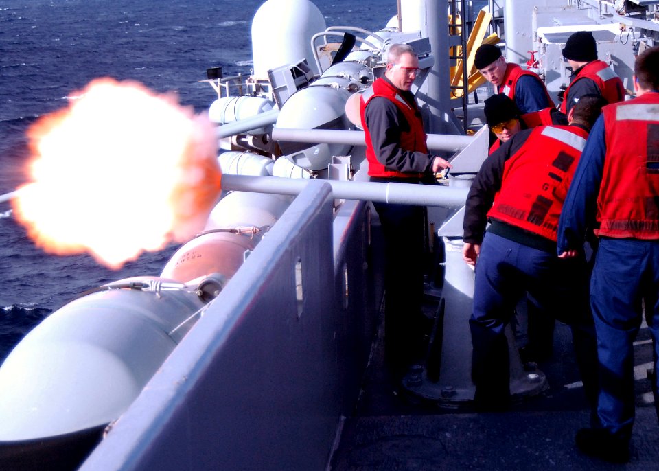 US Navy 070308-N-4565G-002 Gunner's Mate 1st Class Robert A. Clay orders Sailors assigned to weapons department to fire the ceremonial 40mm battery gun aboard USS John F Kennedy (CV 67)