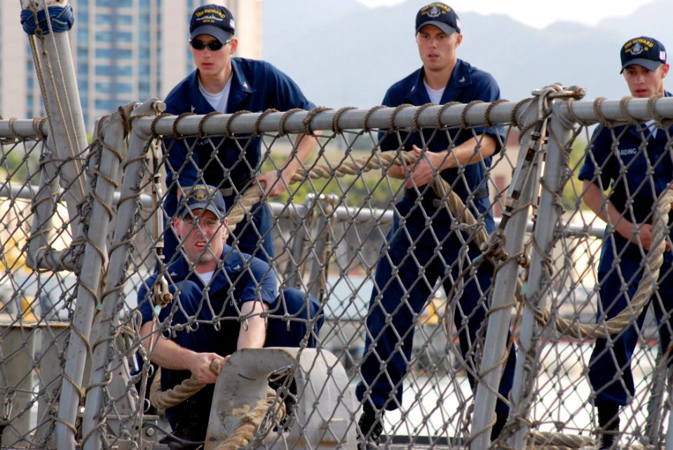 US Navy 070304-N-4965F-014 Sailors aboard guided missile destroyer USS Howard (DDG 83) heave around on a line while mooring pierside Naval Station Pearl Harbor