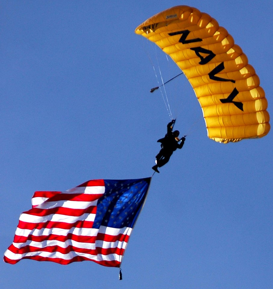 US Navy 070308-N-4163T-189 A member of the U U.S. Navy Parachute Demonstration Team Leap Frogs descends into San Diego's Qualcomm Stadium with the American flag during a training session