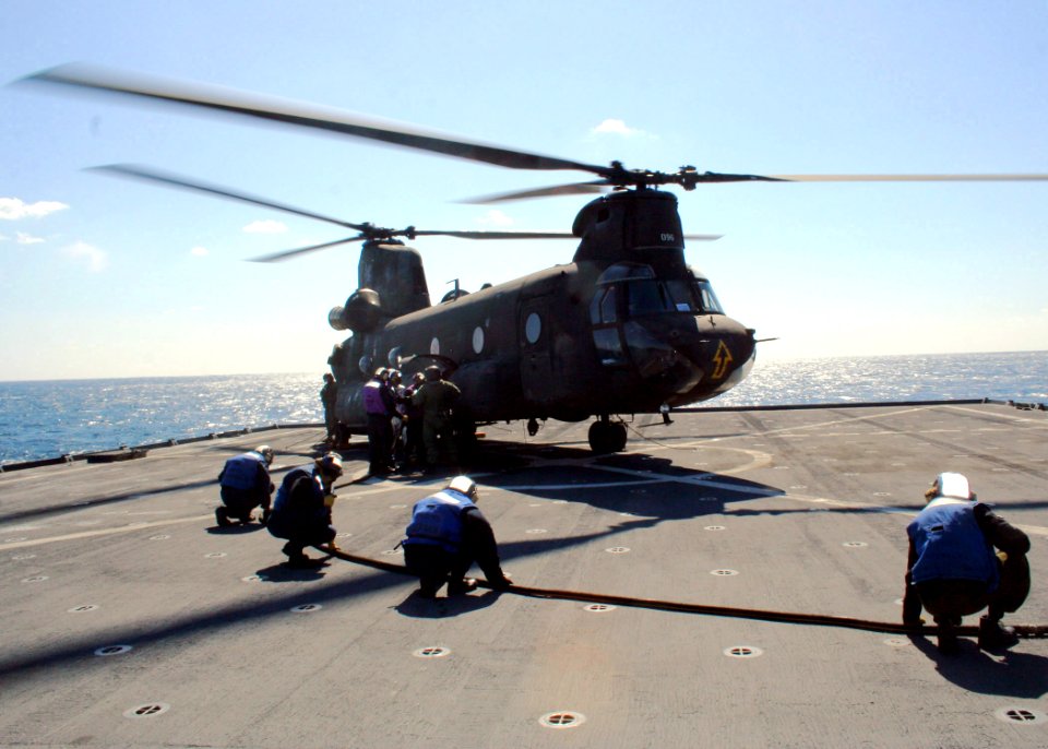 US Navy 070307-N-6710M-005 Members of the amphibious transport dock ship USS Tortuga (LSD 46) refueling crew prepare to refuel an Army CH-47 Chinook during the two services deck landing qualifications