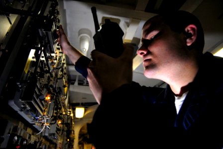 US Navy 070305-N-2659P-061 Electronics Technician Seaman Cliff Bunnowsky checks power inputs for Ultra High Frequency (UHF) radios used for ship-to-ship and shore communications in the Ultra High Frequency radio room