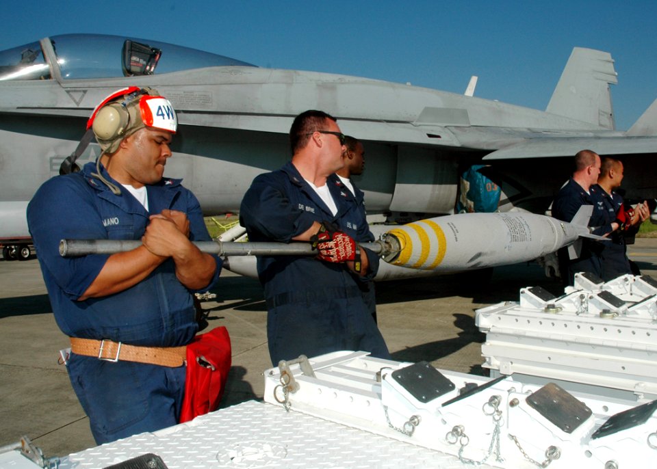 US Navy 070309-N-7427G-002 Ordnance departments assigned to Strike Fighter Squadron (VFA) 204 and Naval Air Station Joint Reserve Base, New Orleans, ready bombs for attachment onto an F-18 during a recent training exercise hos