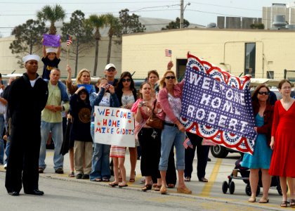 US Navy 070309-N-8544C-013 Family and friends await the arrival of their Sailors from the frigate USS Taylor (FFG 50), as she pulls into its homeport Naval Station Mayport after a successful surge deployment