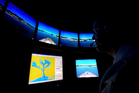 US Navy 070314-N-4965F-012 Quartermaster 1st Class Micky Young, assigned to Afloat Training Group Middle Pacific (ATG MIDPAC), operates the Navigation, Seamanship and Shiphandling Trainer (NSST) master control station