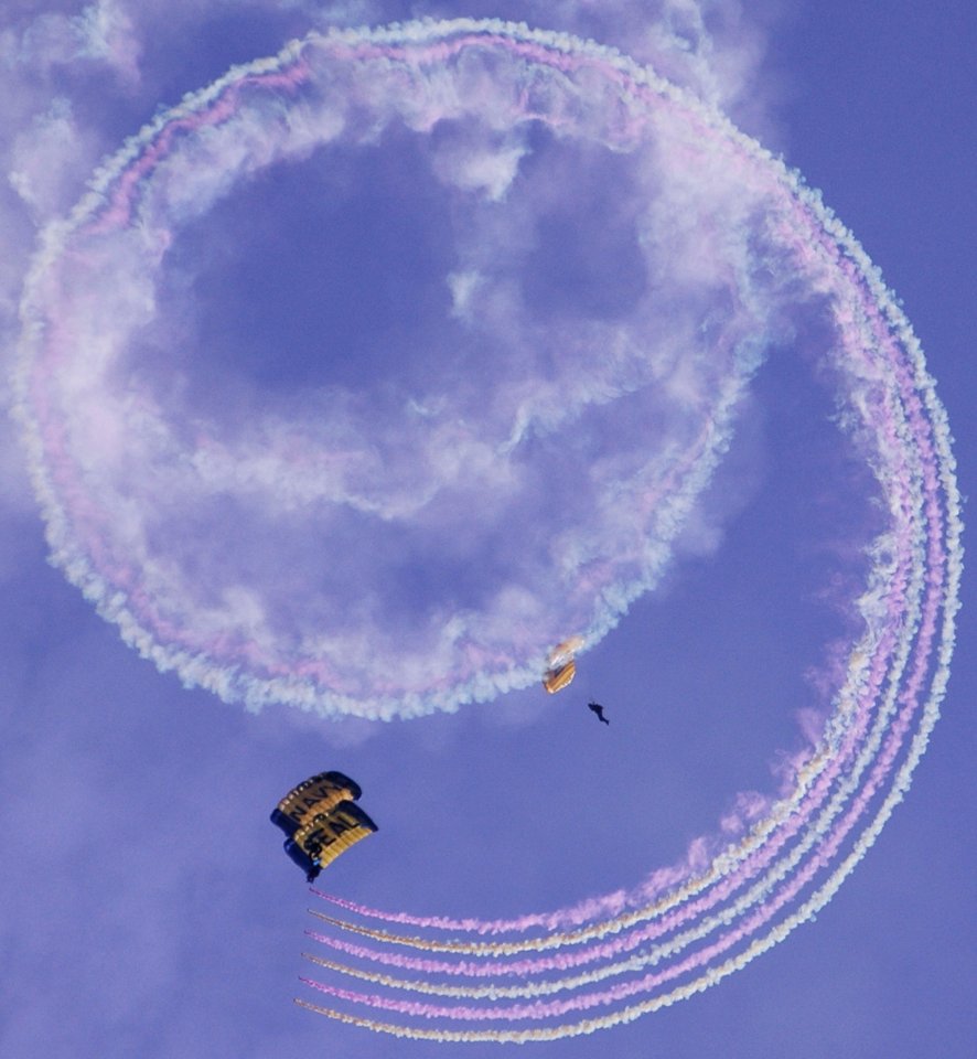 US Navy 070308-N-4163T-302 Members of the U.S. Navy Parachute Demonstration Team Leap Frogs descend into San Diego's Qualcomm Stadium trailing smoke grenade as part of a training session