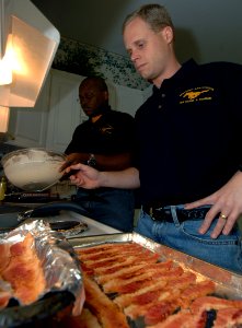 US Navy 070314-N-8923M-017 USS Harry S. Truman (CVN 75) Mustang Association members Lt. Cmdr. Eugene Mincey, left, and Ensign Scott Metcalf prepare breakfast in the kitchen of the Ronald McDonald House