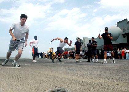 US Navy 070309-N-0209M-005 Sailors assigned aboard amphibious assault ship USS Boxer (LHD 4) take off running during a 5K Captain's Cup relay race held on the ship's flight deck