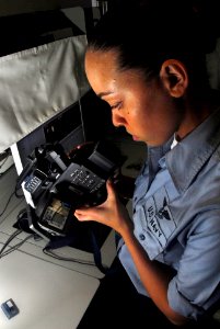 US Navy 070310-N-9928E-029 Mass Communication Specialist Seaman Leah Allen reviews recorded video footage in preparation for digitizing and b-roll production in media department's video workshop photo