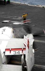 US Navy 070315-N-3659B-001 An aircraft handler directs a C-2A Greyhound, assigned to