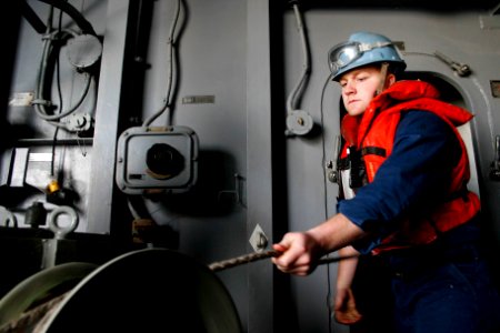 US Navy 070308-N-1328S-001 Seaman Recruit Breck Stephenson pulls line aboard amphibious assault ship USS Boxer (LHD 4) during an underway replenishment with Military Sealift Command (MSC) fast combat support ship USNS Arctic (T