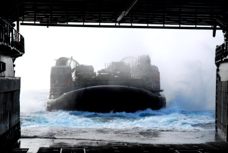 US Navy 070310-N-4124C-009 A landing craft air cushion (LCAC) assigned to Assault Craft Unit (ACU) 5, Detachment Western Pacific, readies itself to enter the well deck of dock landing ship USS Harpers Ferry (LSD 49) photo