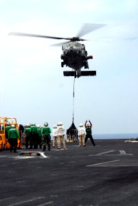 US Navy 070314-N-3659B-070 A landing signalman enlisted (LSE) sends hand signals to the pilot of an MH-60S Seahawk