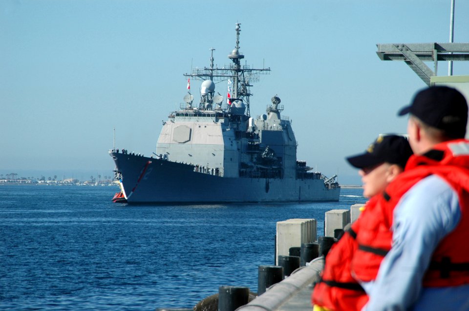 US Navy 070313-N-4047W-137 Fire Controlman 2nd Class Jason Hall and Fireman Stephanie Williams, stationed on board USS Halsey (DDG 97), look on as guided missile cruiser USS Bunker Hill (CG 52) approaches the pier
