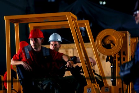 US Navy 070309-N-9928E-105 Airman Johnny Fauks prepares to load pallets received from Military Sealift Command (MSC) fast combat support ship USNS Bridge (T-AOE 10) during a replenishment at sea aboard Nimitz-class aircraft car