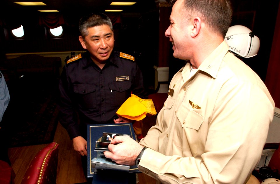 US Navy 070316-N-9712C-004 USS Ronald Reagan (CVN 76) Commanding Officer, Capt. Terry Kraft hands a photo album to Japan Maritime Self Defense Force (JMSDF) Commander, Escort Flotilla Three (CCF3) Rear Adm. Yukitaka Miyazaki as