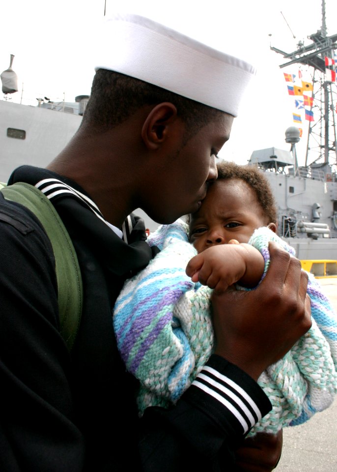 US Navy 070309-N-8544C-043 Seaman Brandon King Sr. embraces his five-month old son for the first time at the homecoming ceremony for guided missile frigate USS Taylor (FFG 50)