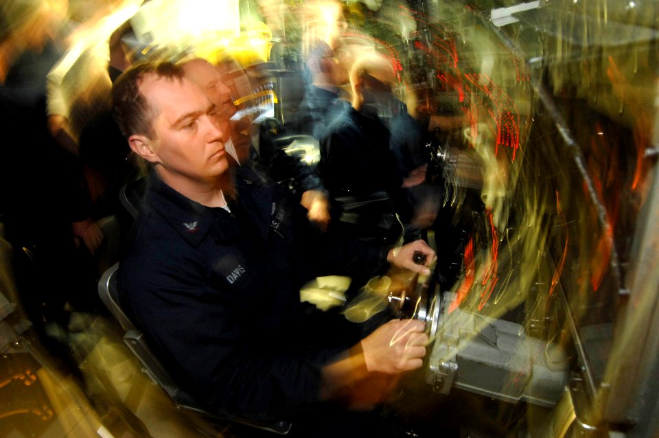 US Navy 070317-N-3642E-460 Machinist's Mate 3rd Class Joshua Davis, USS Alexandria's (SSN 757) helms bow planesmen watches a depth gage during a stationary ascent through approximately three feet of ice