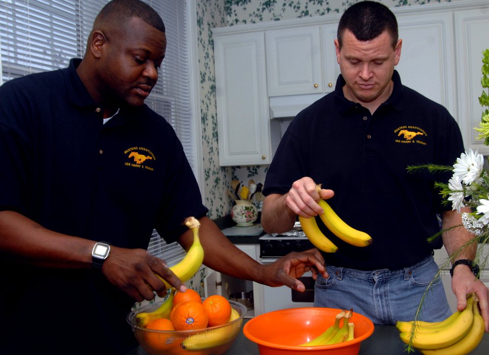 US Navy 070314-N-8923M-007 Chief Warrant Officer Carl Smith and Chief Warrant Officer Michael Sword, members of the Mustang Association aboard Nimitz-class aircraft carrier USS Harry S. Truman (CVN 75), prepare a fruit bowl
